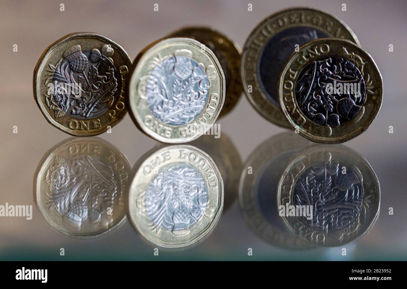 UK Pound coins and a £2 coin shot macro on a reflective surface Stock Photo