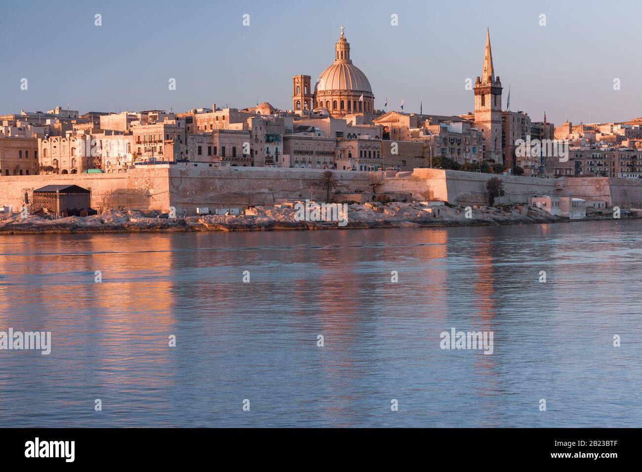 Valletta with Our Lady of Mount Carmel church and St. Paul's Anglican Pro-Cathedral at sunrise as seen from Sliema, Valletta, Malta Stock Photo