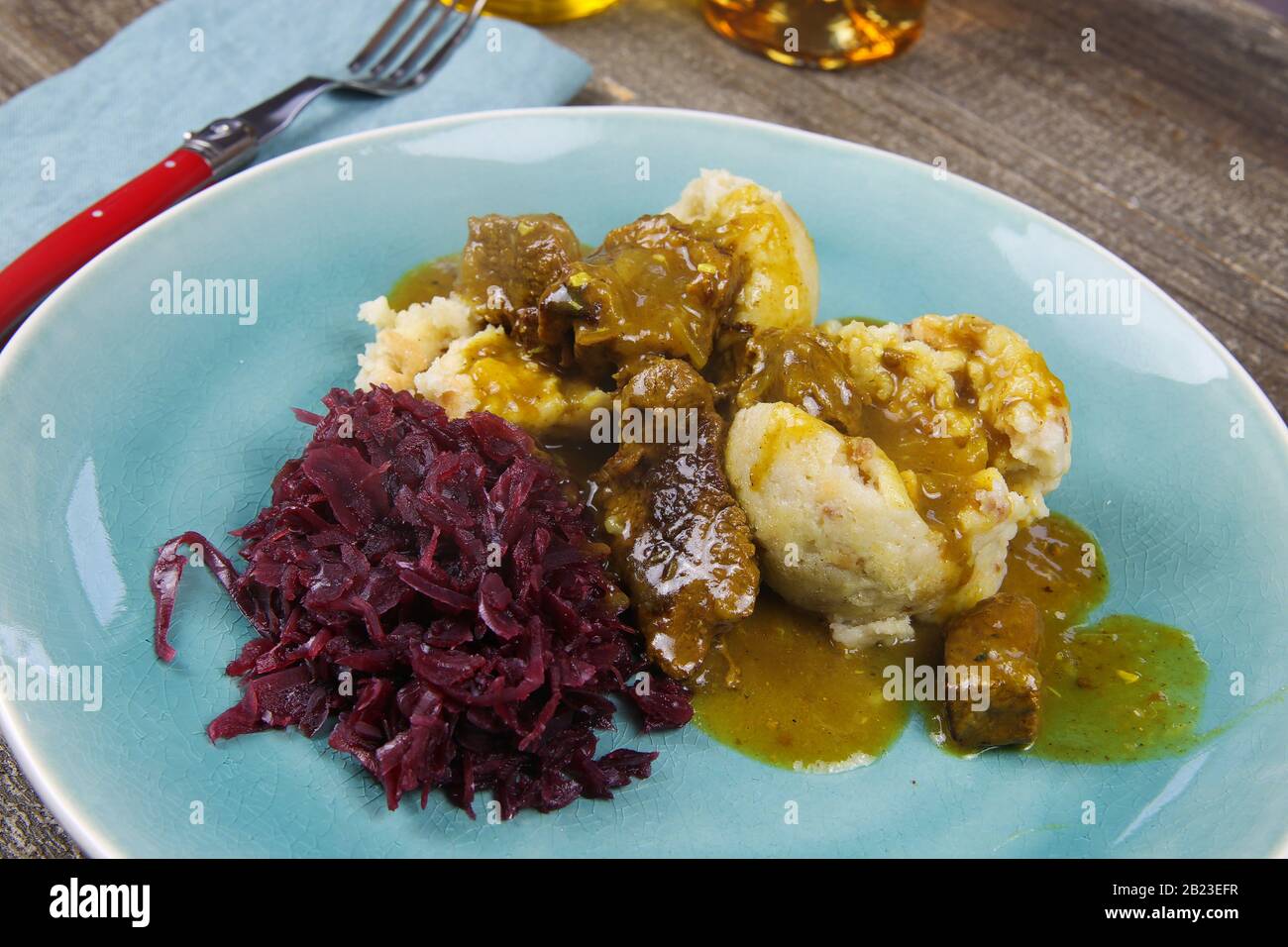 Typical german hearty meal closeup of dumplings with brown sauce, red
