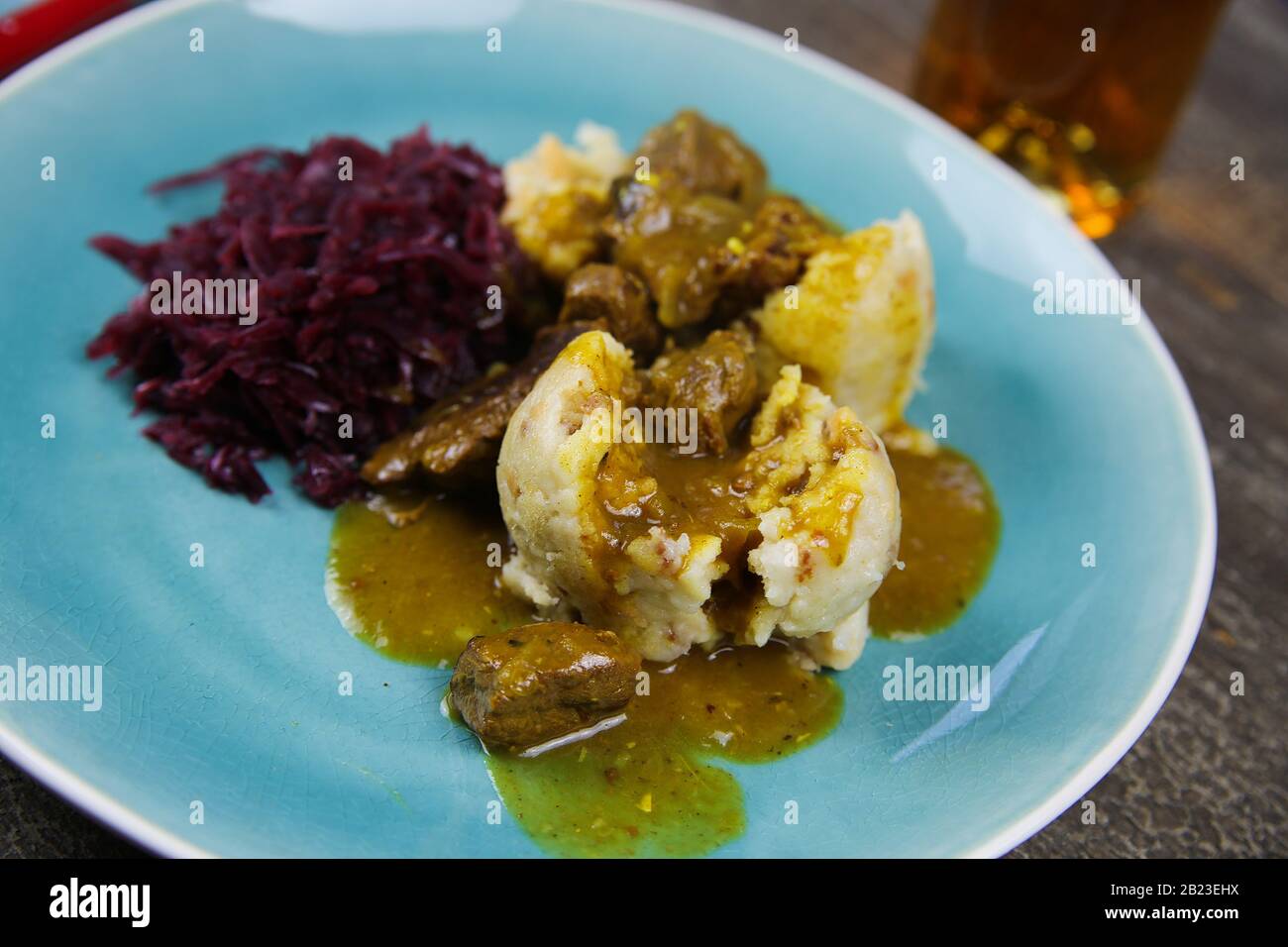 Typical german hearty meal closeup of dumplings with brown sauce, red