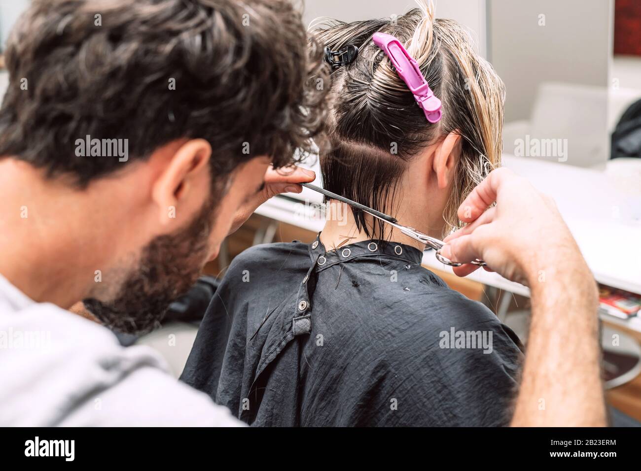 Master hairdresser cuts hair of blond woman in salon. Close up photo Stock Photo Alamy
