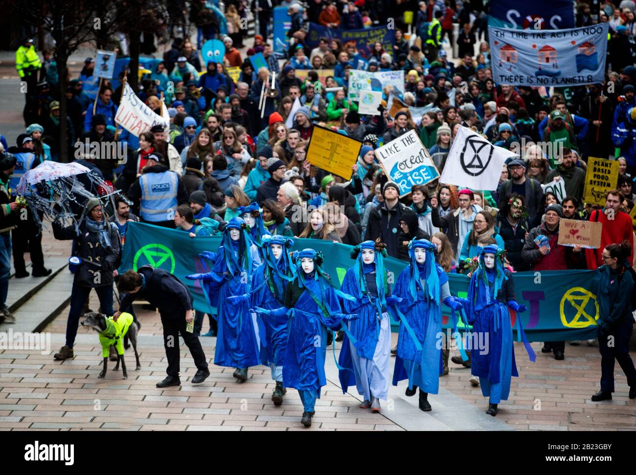 The Blue Rebels lead hundreds of people in the Blue Wave parade, organised by Extinction Rebellion, through Glasgow city centre to raise awareness of the dangers Glasgow and the world faces from flooding caused by rising sea levels and an increased occurrence of storms. Stock Photo