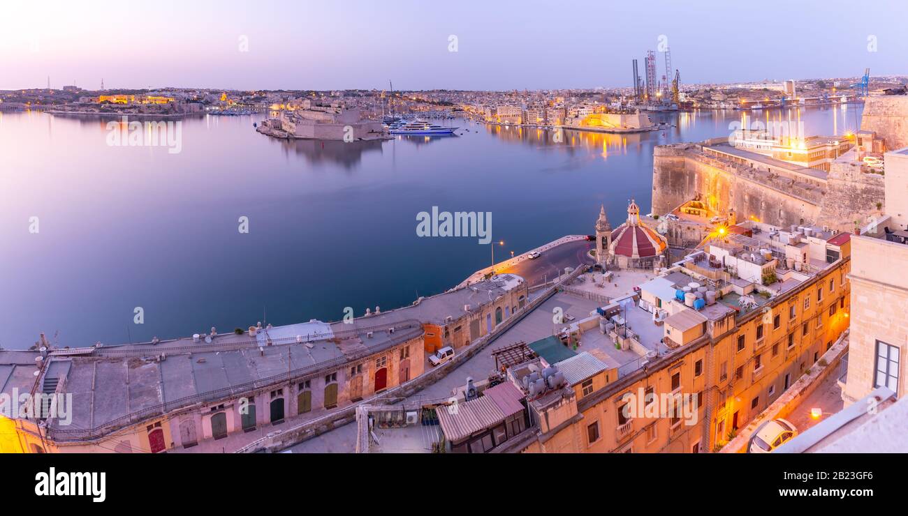 Panoramic view of ancient defences of Valletta, Grand Harbor and Three fortified cities of Birgu, Senglea and Cospicua, at sunrise, Valletta, Malta. Stock Photo