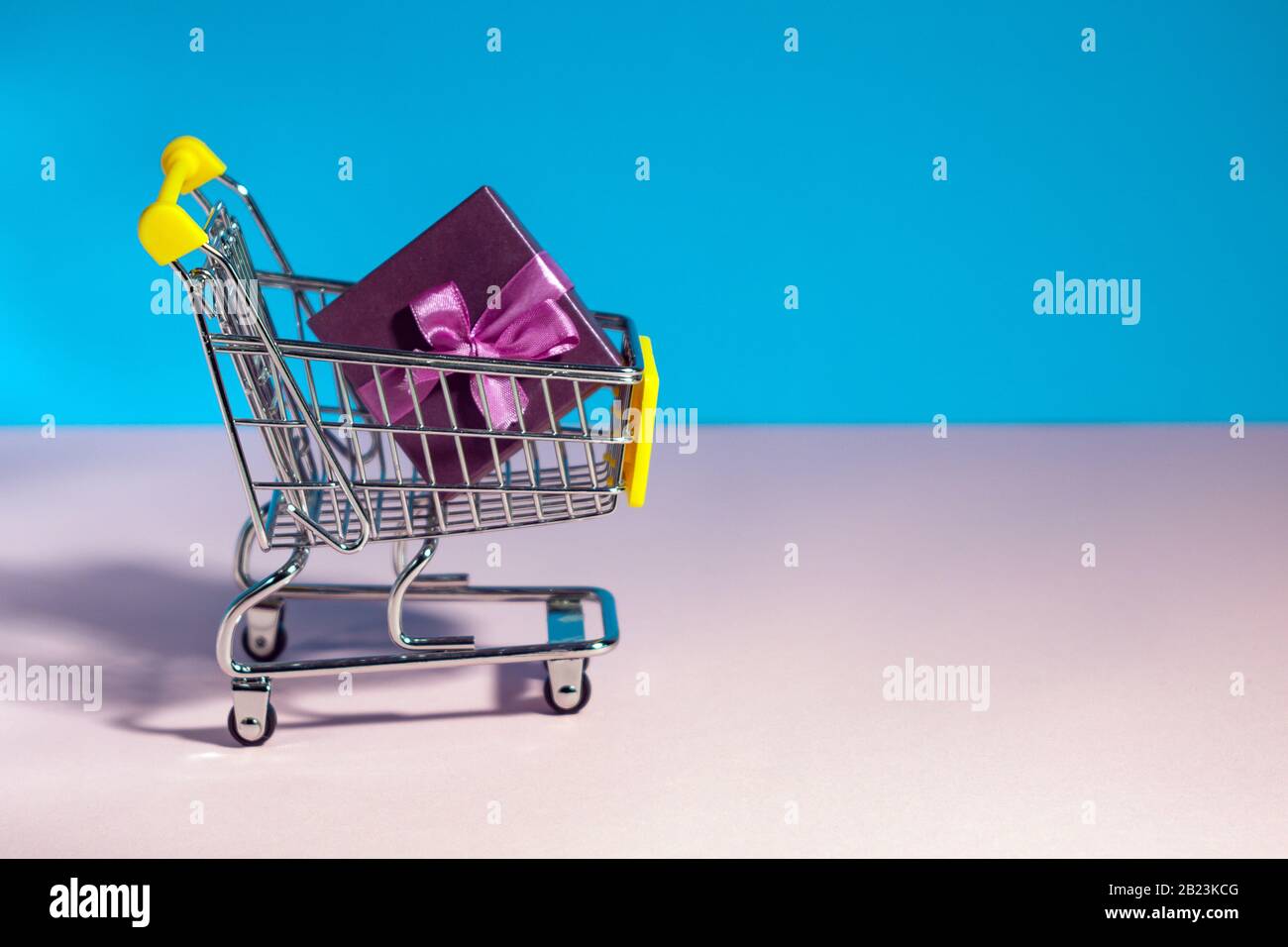 Collection of shopping cart full of shopping time. composition cart on color background. Stock Photo