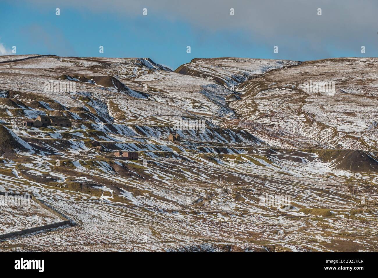 The remains of the Coldberry lead mine in a patchy snow covering, Hudes Hope Valley, Teesdale Stock Photo