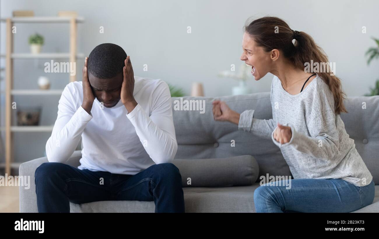 Unhappy African American couple quarreling, fighting at home Stock Photo