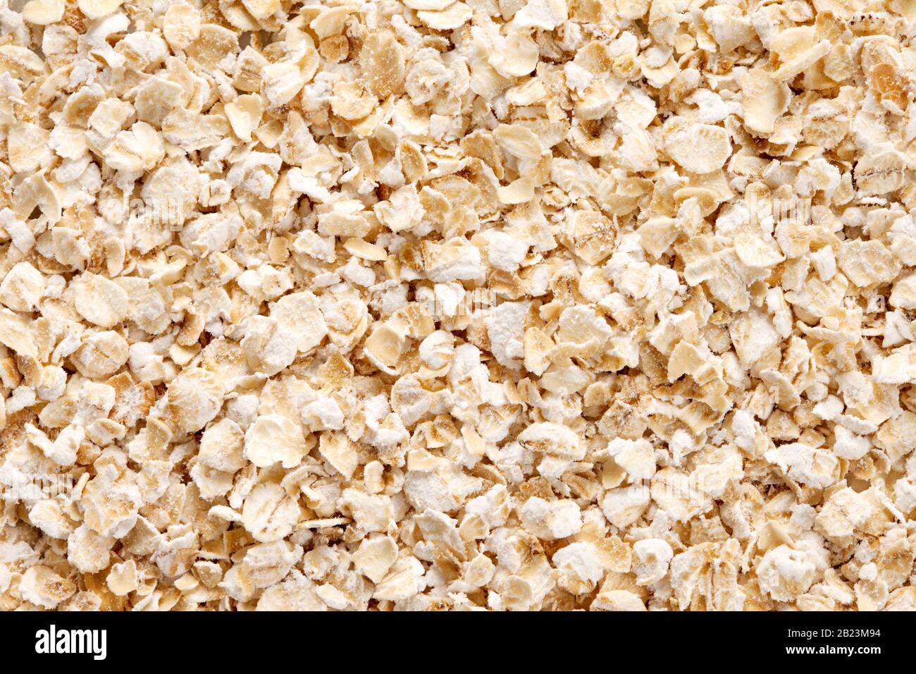 Oatmeal (rolled oats) texture, full frame background . Oats is an excellent source of  thiamine, iron and fiber. Stock Photo