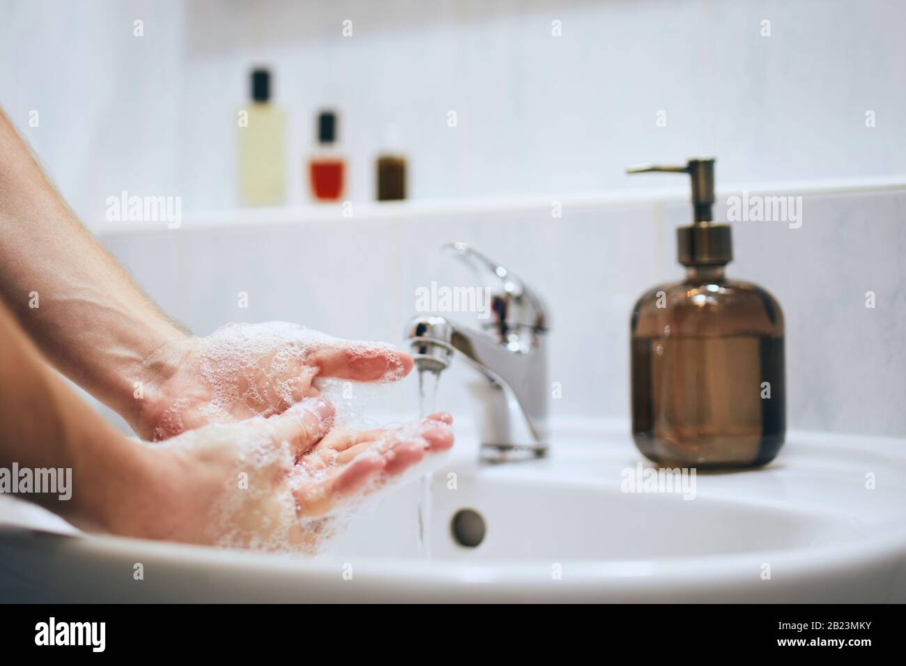 Washing hands at home in bathroom. Healthy lifestyle, hygiene and prevention viral and bacterial diseases. Stock Photo
