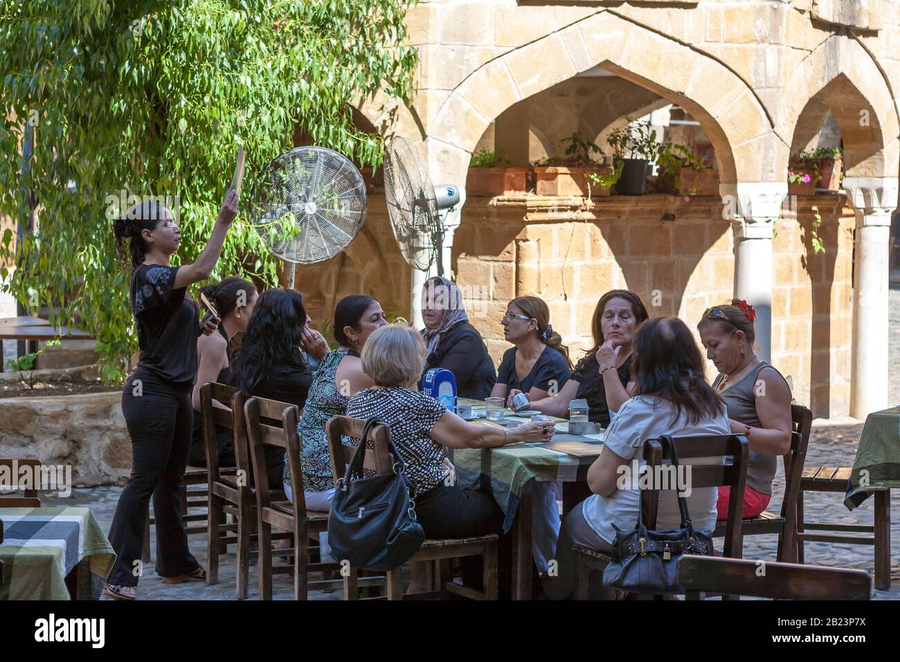 Ladies lunching in the courtyard of the Büyük Han, the famous caravanserai on Asmaalti Sokak, North Nicosia, Turkish Cyprus Stock Photo