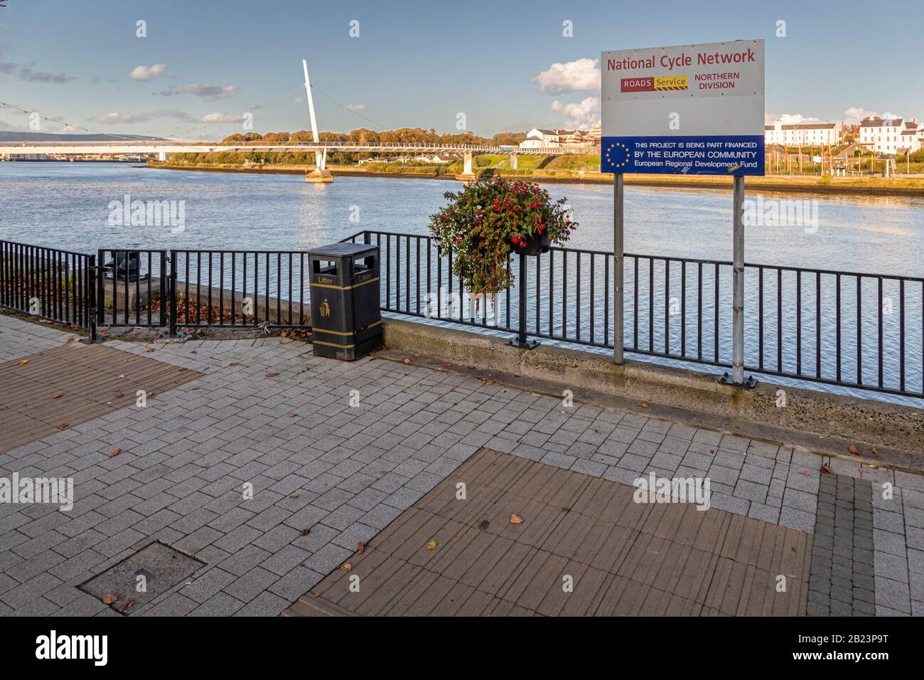 A National Cycle Network sign stands on the cycle path of Foyle Street in Londonderry, County Derry, Northern Ireland, on the bank of the River Foyle. The UK-wide cycling network, developed since 1995 by the charity Sustrans, links towns and regions across Britain and Northern Ireland. Stock Photo
