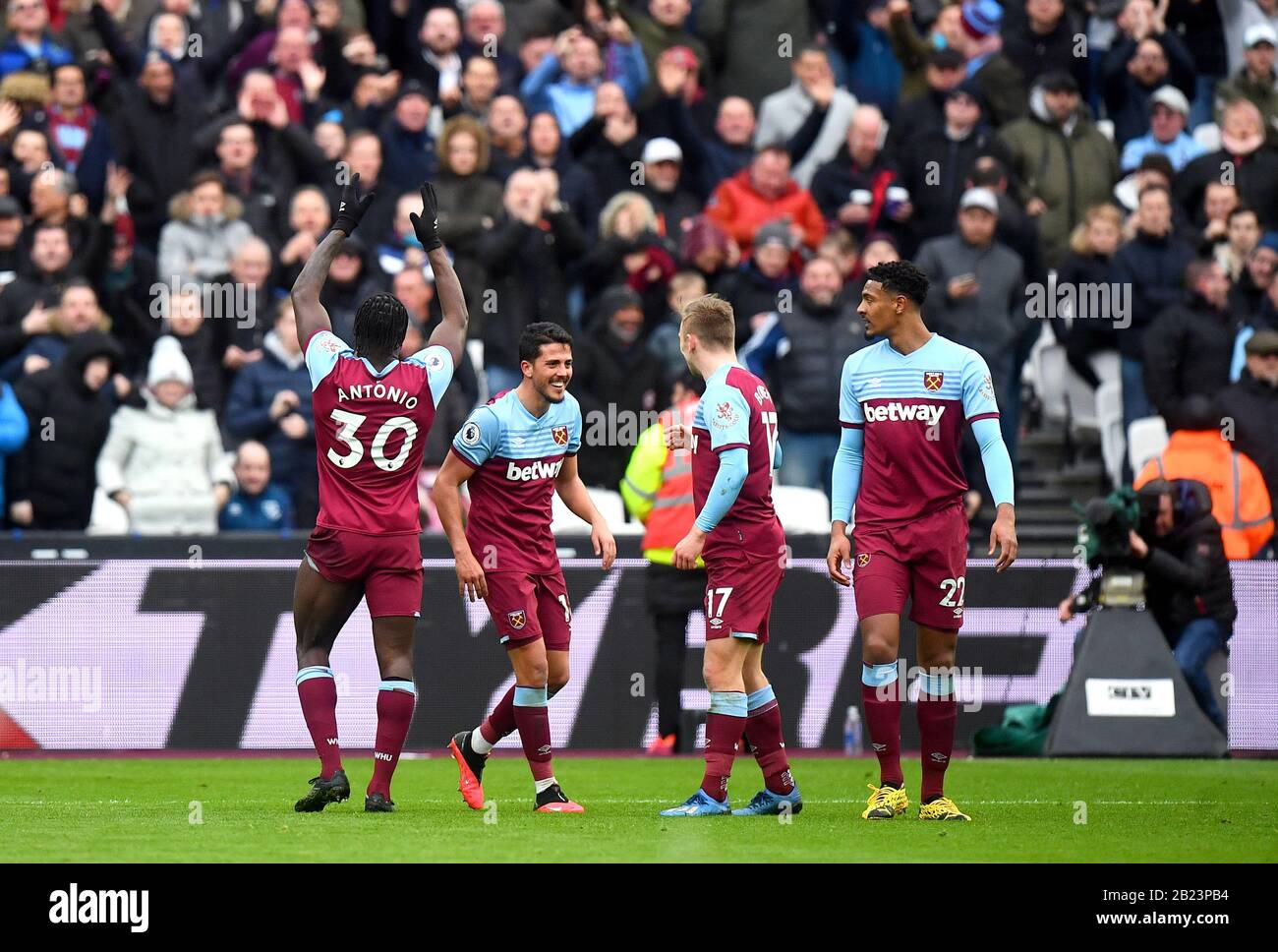 West Ham United's Michail Antonio (left) celebrates scoring his side's  third goal of the game in front of the home fans during the Premier League  match at London Stadium Stock Photo -