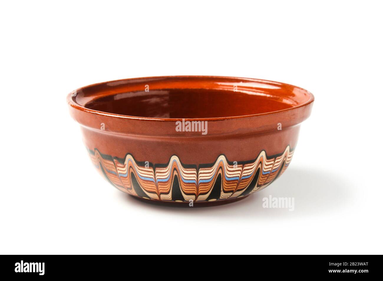 Old clay cup with a multi-colored pattern isolated on white Stock Photo