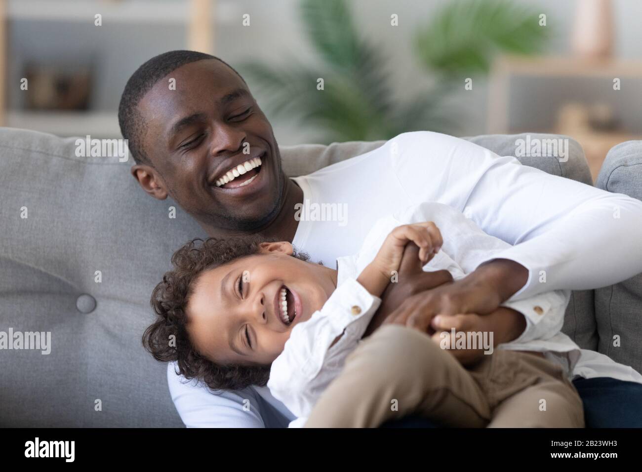 Happy African American father and little son having fun together Stock ...