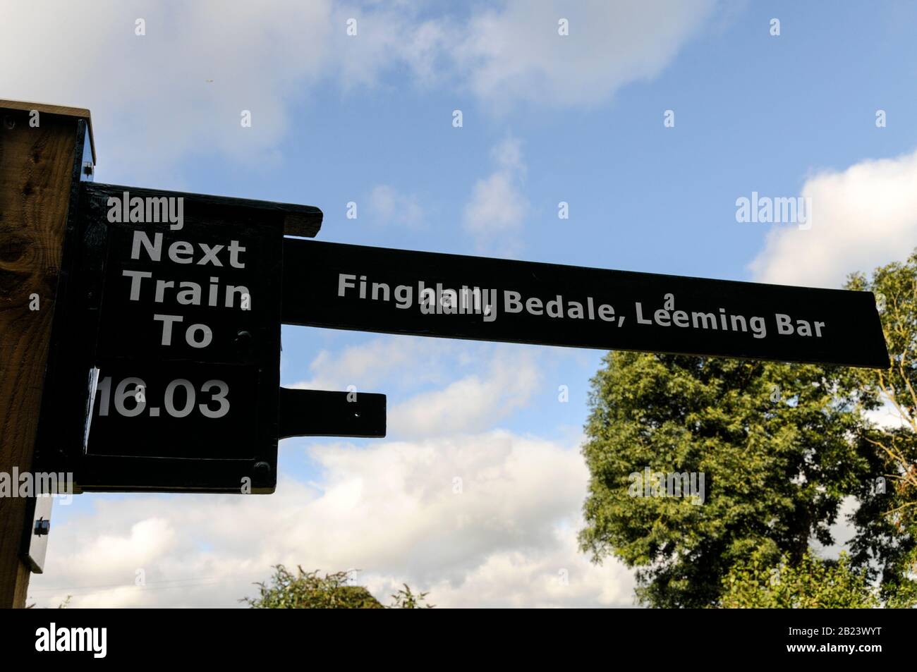 A rail signpost, indicating the time of the next train at Leyburn rail station in the Yorkshire Dales, Britain.  The revived Wensleydale tourist/ heritage Stock Photo