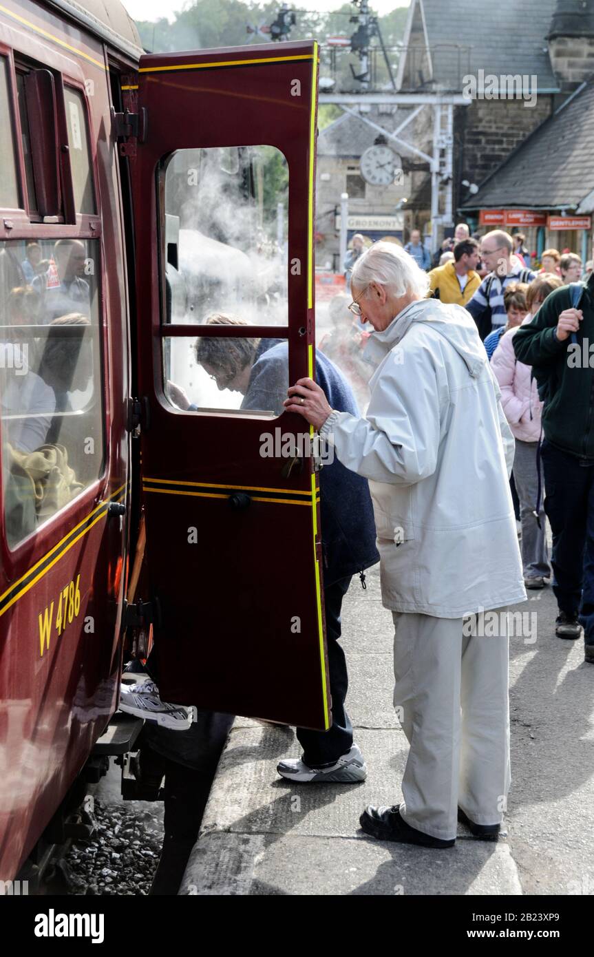 Passengers boarding  the steam train at Grosmont rail station part of the North York Moors Railway (NYMR) in the North York moors, Britain Stock Photo