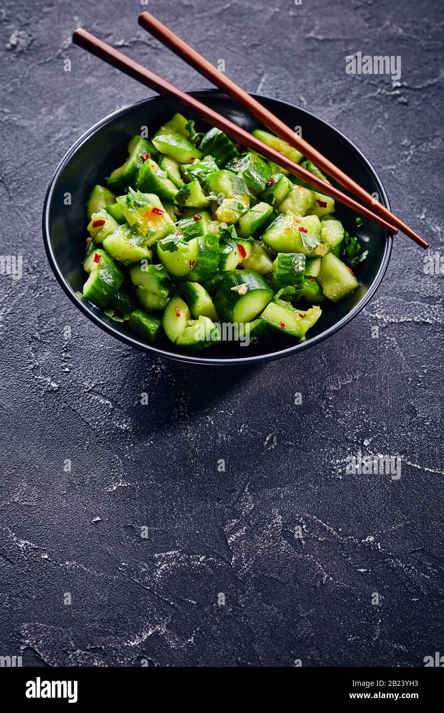 Chinese Smashed Cucumber salad sprinkled with fresh coriander leaves
