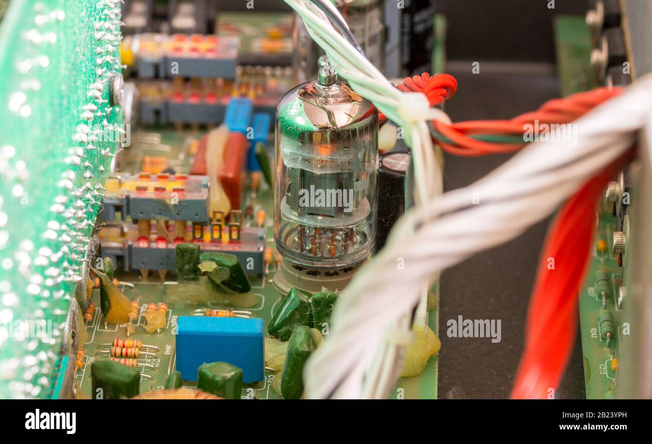 Electrical assembly with glowing tube on a circuit board with electrical components and cables