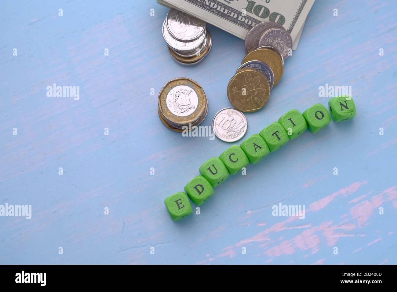 top view of education text and coin on table. saving money for education concept Stock Photo