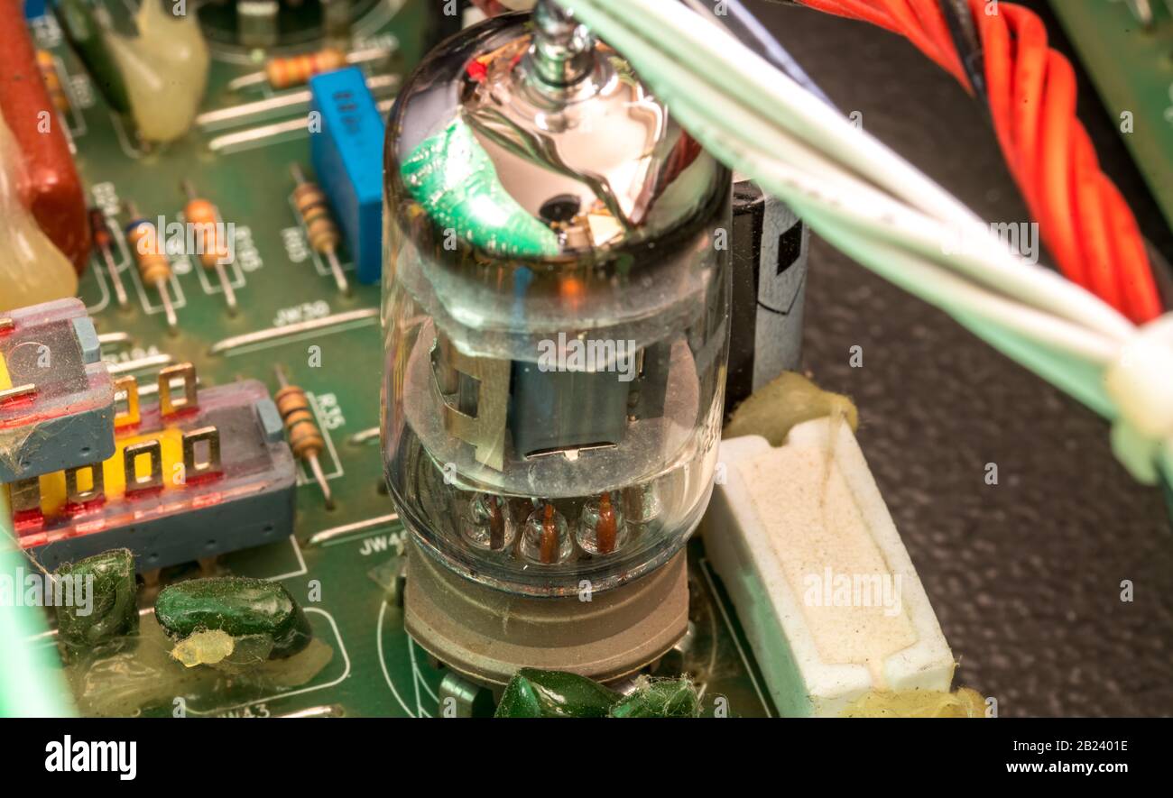 Electrical assembly with glowing tube on a circuit board with electrical components and cables