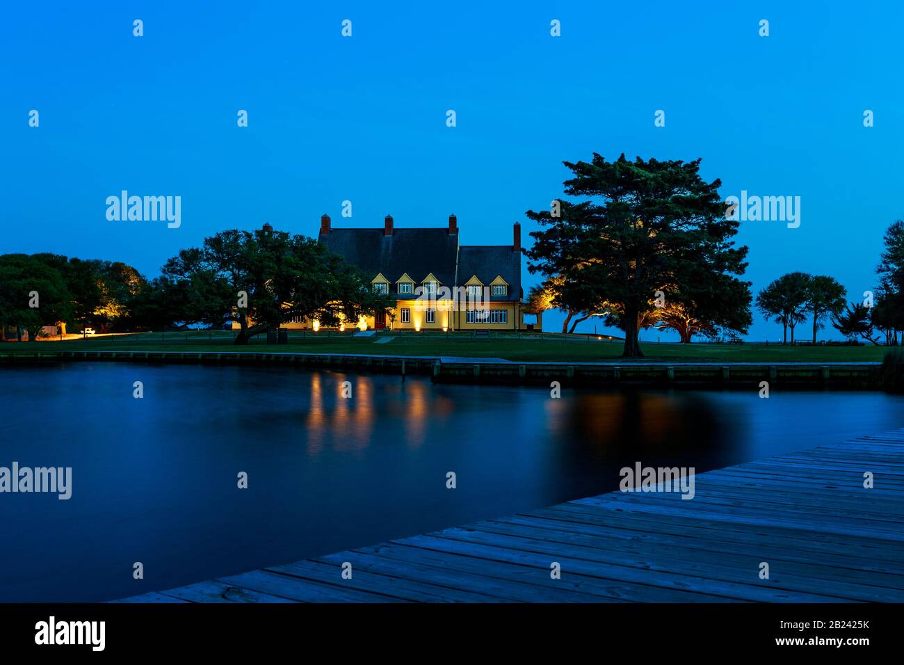 Blue nightscape, Whalehead Club, with lights, deck and water, Corolla, NC, May 28, 2013 Stock Photo