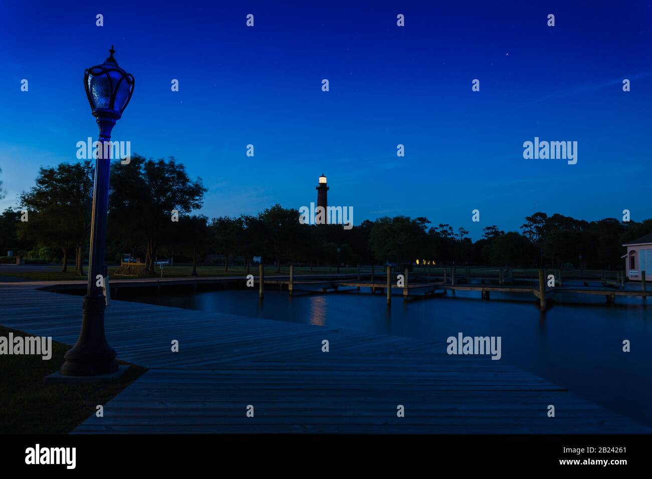 Deep blue nightscape, water and lighthouse, Whalehead Club, Corolla, NC, May 31, 2013 Stock Photo
