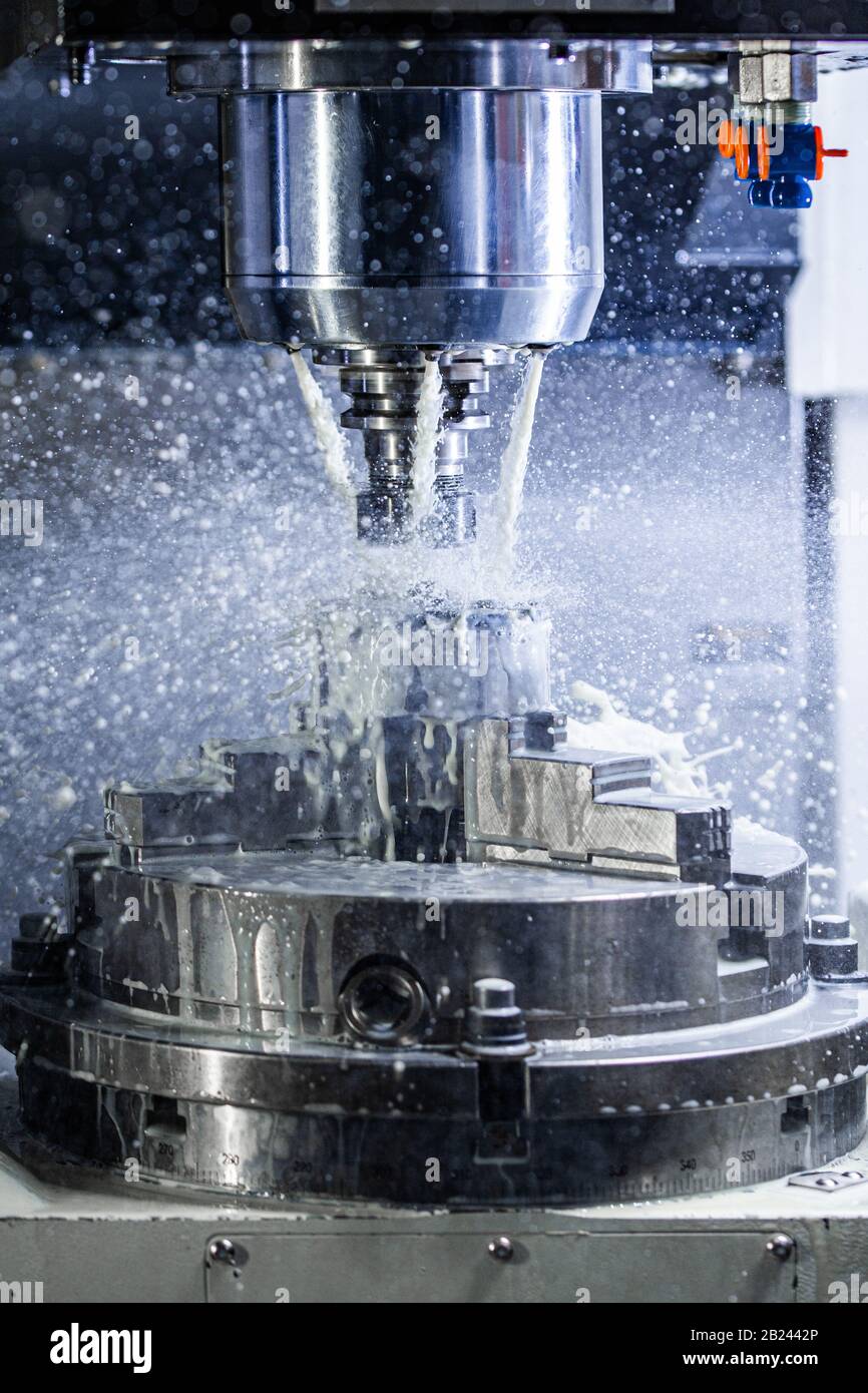 Vertical photo of industrial wet milling process in 5axis cnc machine