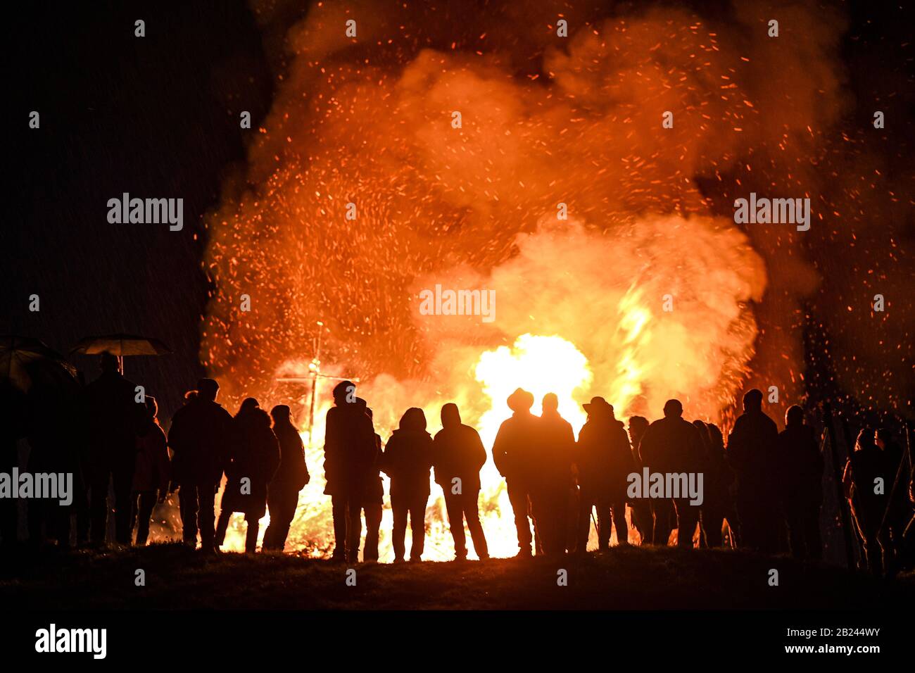 Meersburg, Germany. 29th Feb, 2020. Visitors look at the spark fire that was lit in the evening at the Wetterkreuz above Lake Constance. Credit: Felix Kästle/dpa/Alamy Live News Stock Photo