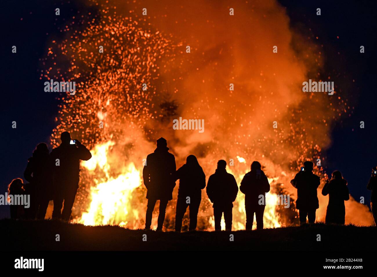 Meersburg, Germany. 29th Feb, 2020. Visitors look at the spark fire that was lit in the evening at the Wetterkreuz above Lake Constance. Credit: Felix Kästle/dpa/Alamy Live News Stock Photo