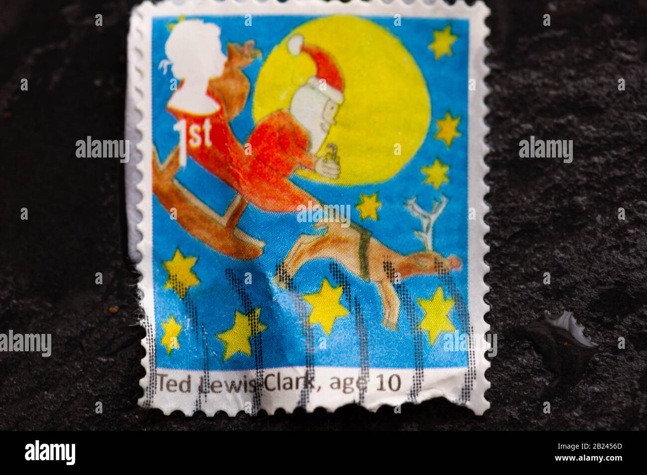 Festive Christmas concept -  Close-up of a Father Christmas & reindeer postage stamp. Editorial only. Stock Photo