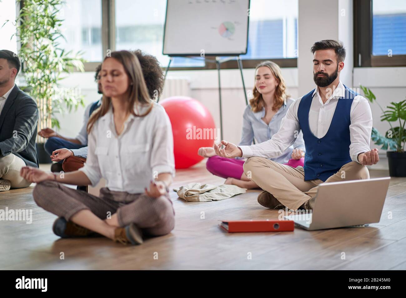 Business man meditating at work.group of business coworkers meditating together at work. Stock Photo