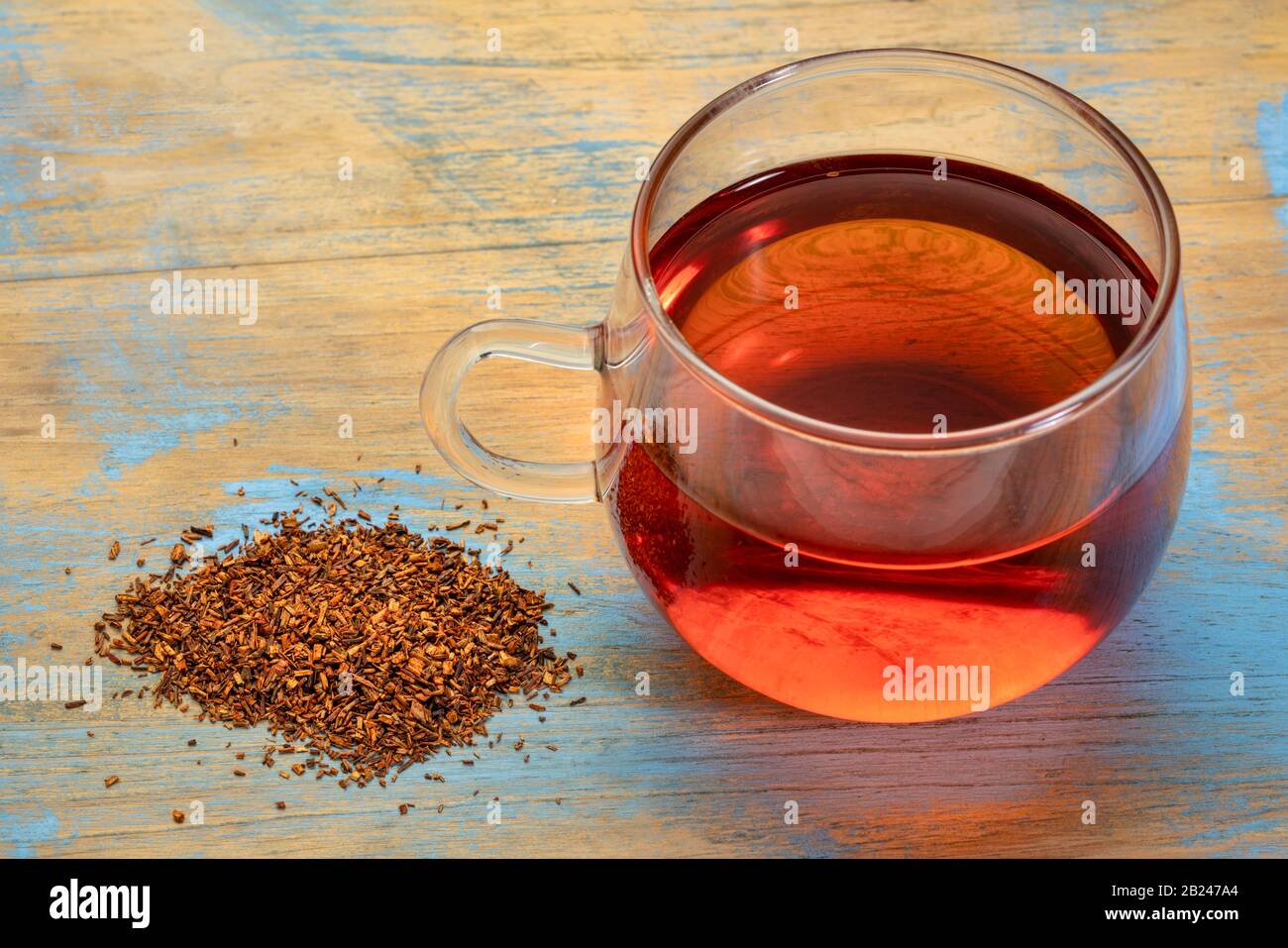 rooibos red tea - a glass cup of a hot drink and loose leaves, tea made from the South African bush, naturally caffeine free Stock - Alamy