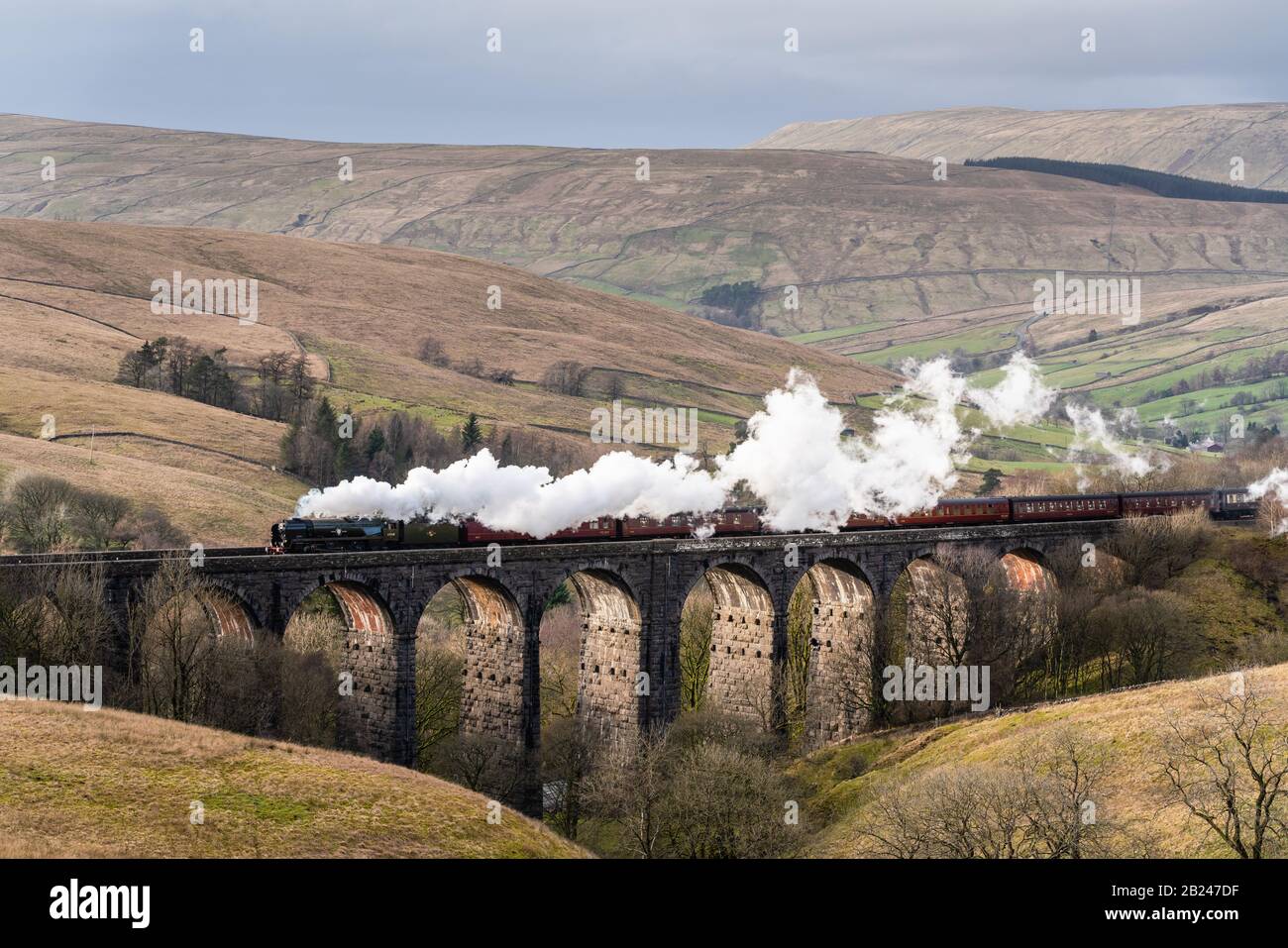 Sedbergh, Yorkshire Dales. 29th Feb, 2020. British India Line (number 35018), a preserved SR Merchant Navy Class steam locomotive, built by the Southern Railway in 1945, passing over Dent Head Viaduct, on the famous Settle-Carlisle railway in the Yorkshire Dales National Park, working a Winter Cumbrian Mountain Express tour from Carlisle to London on Saturday, February 29, 2020. Credit: Christopher Middleton/Alamy Live News Stock Photo