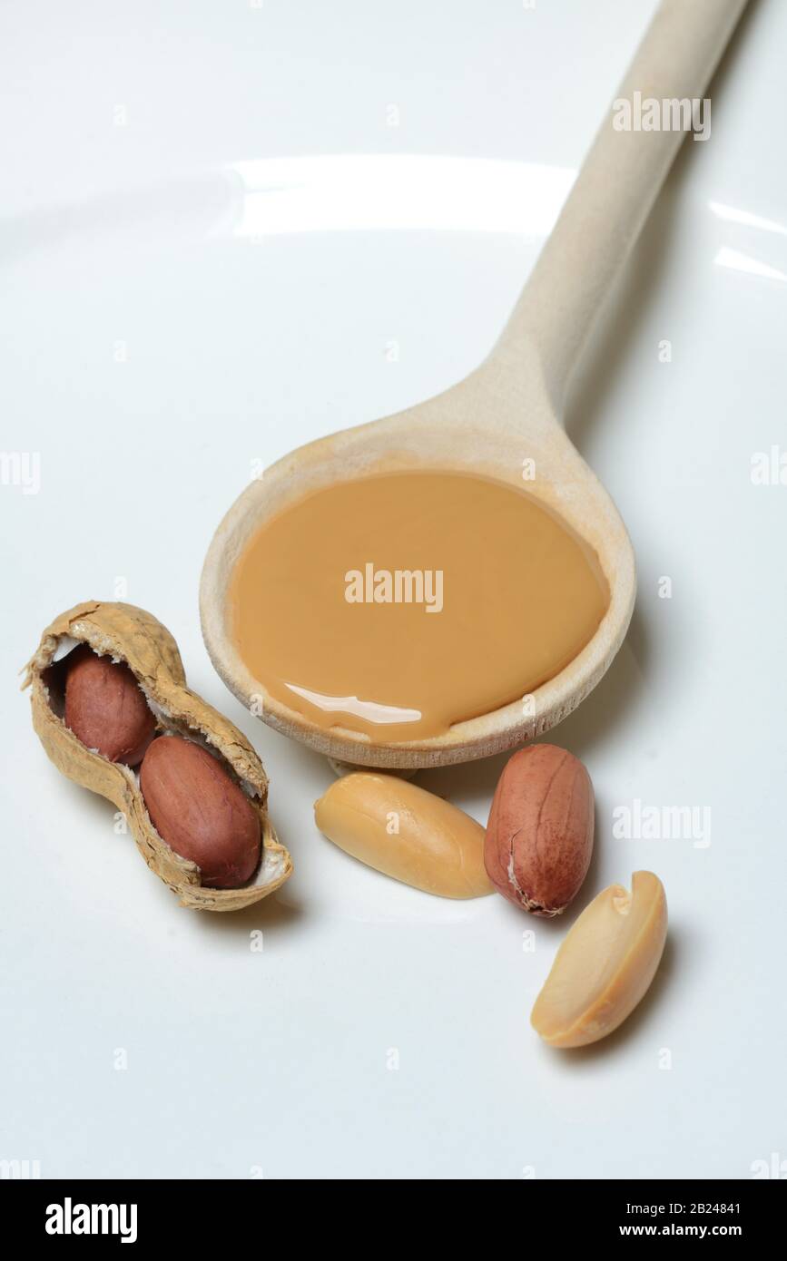 Wooden spoon of peanut butter Stock Photo by Alex9500
