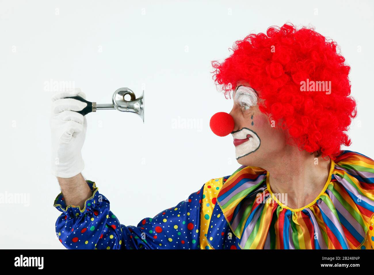 Clown honks his horn, Germany Stock Photo - Alamy