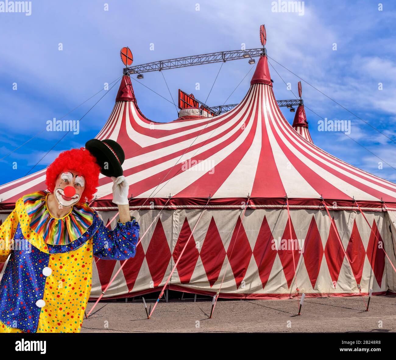 FOTOMONTAGE, Clown greets with hat in front of circus tent, Germany Stock Photo