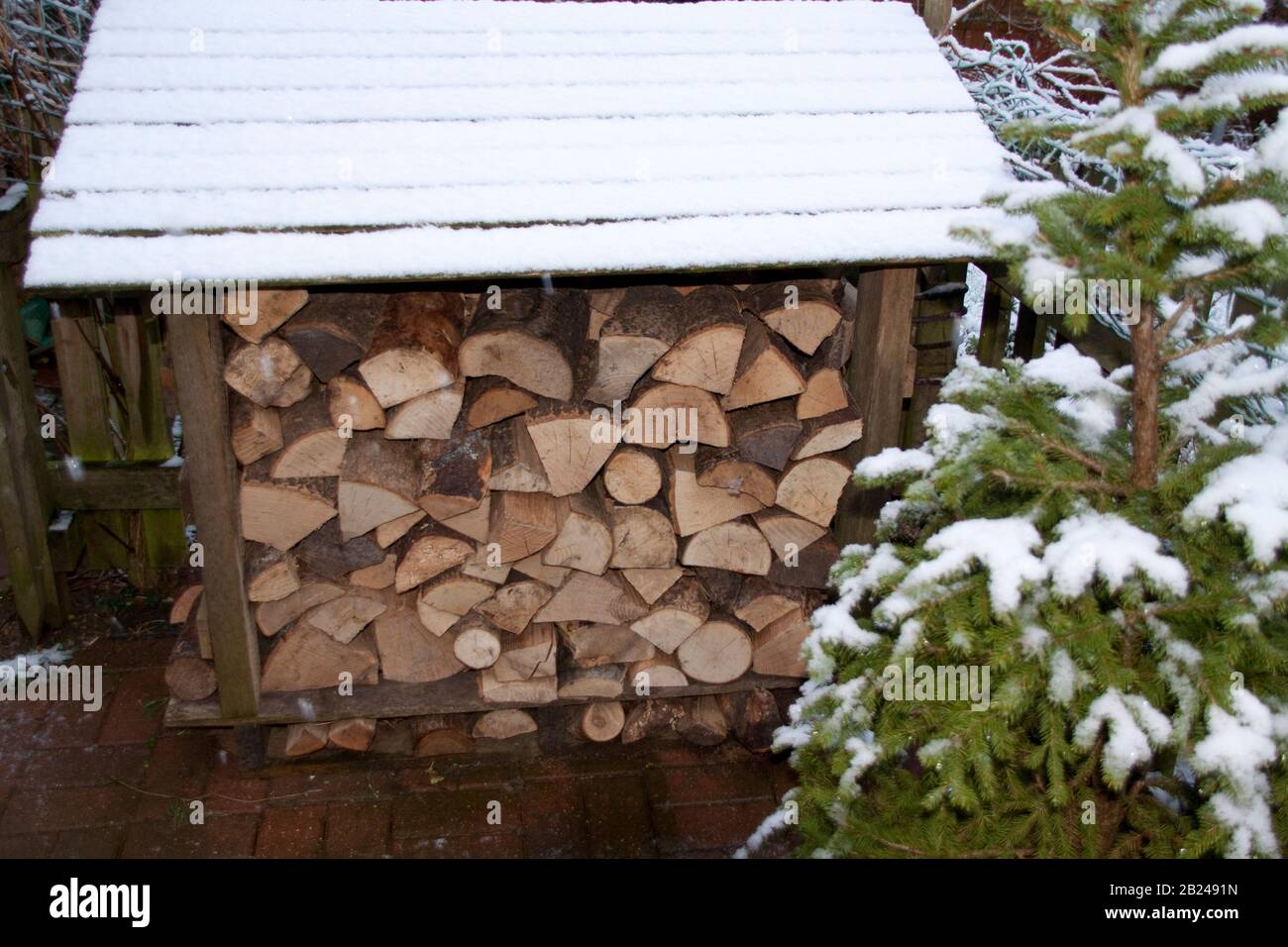 Log store in garden Stock Photo