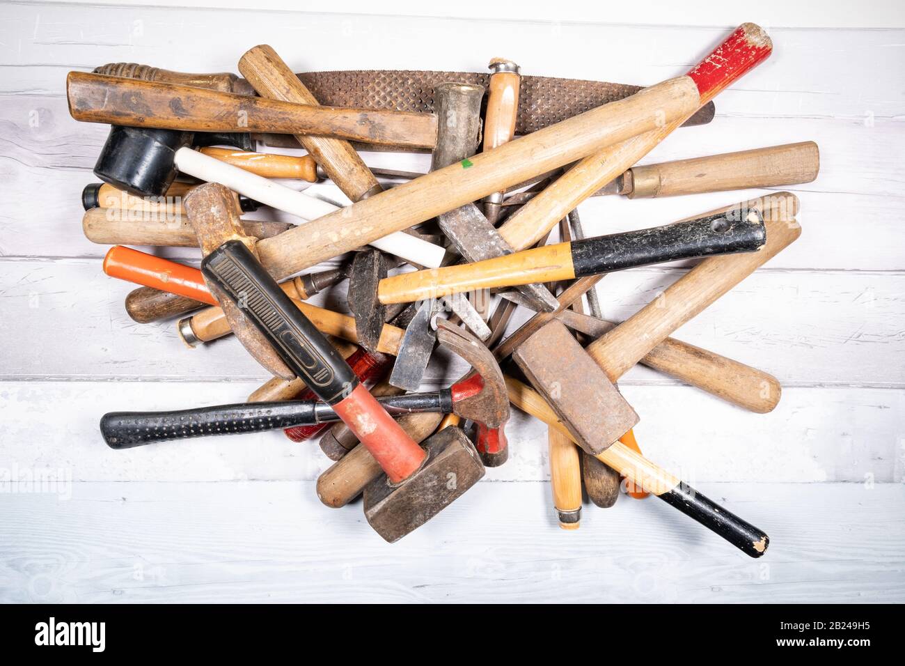 Sets of different wood rasps, hammers and wood chisels in the middle of ...