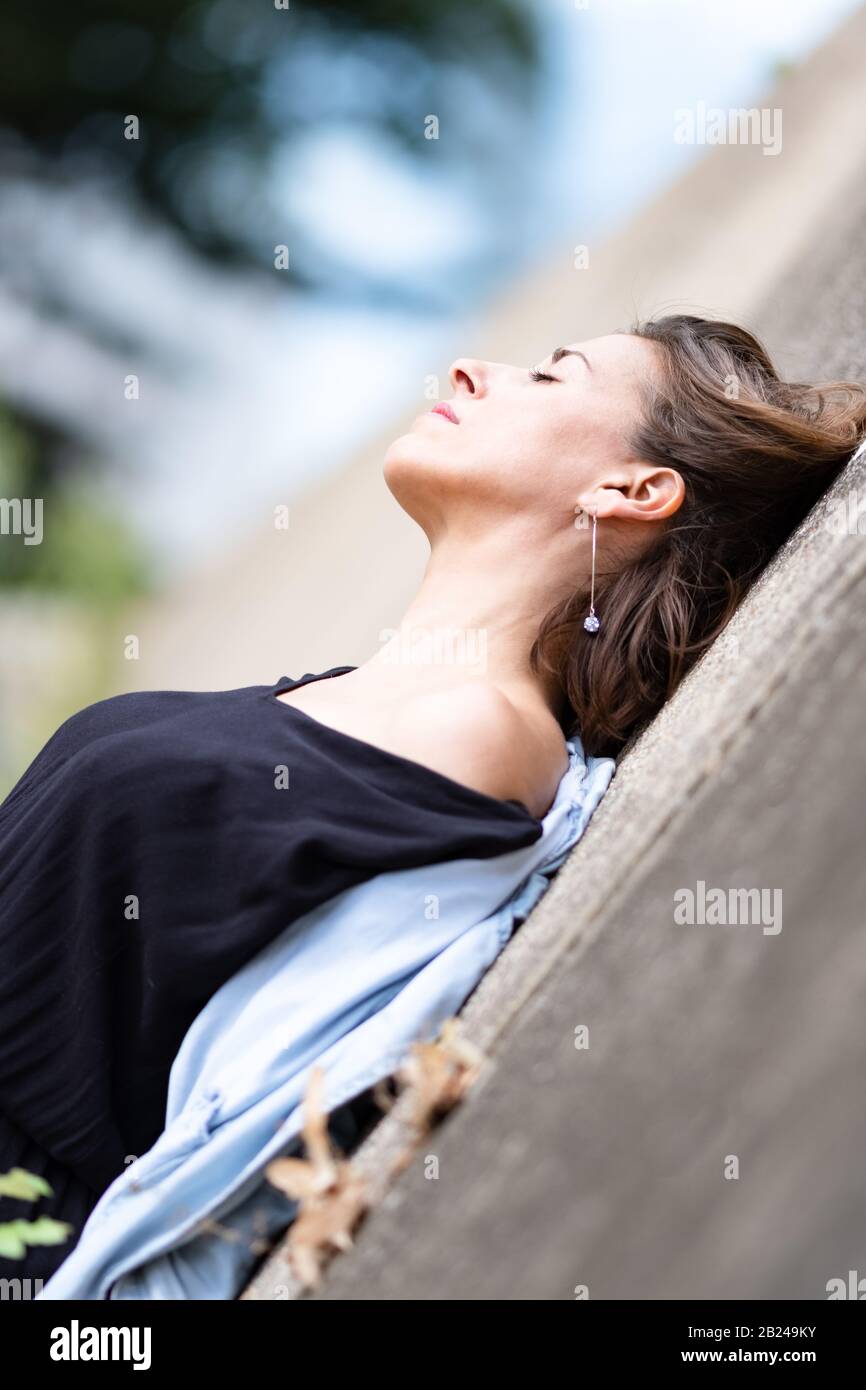 the well being of a beautiful natural woman who closes her eyes and who is in her dreams. Stock Photo