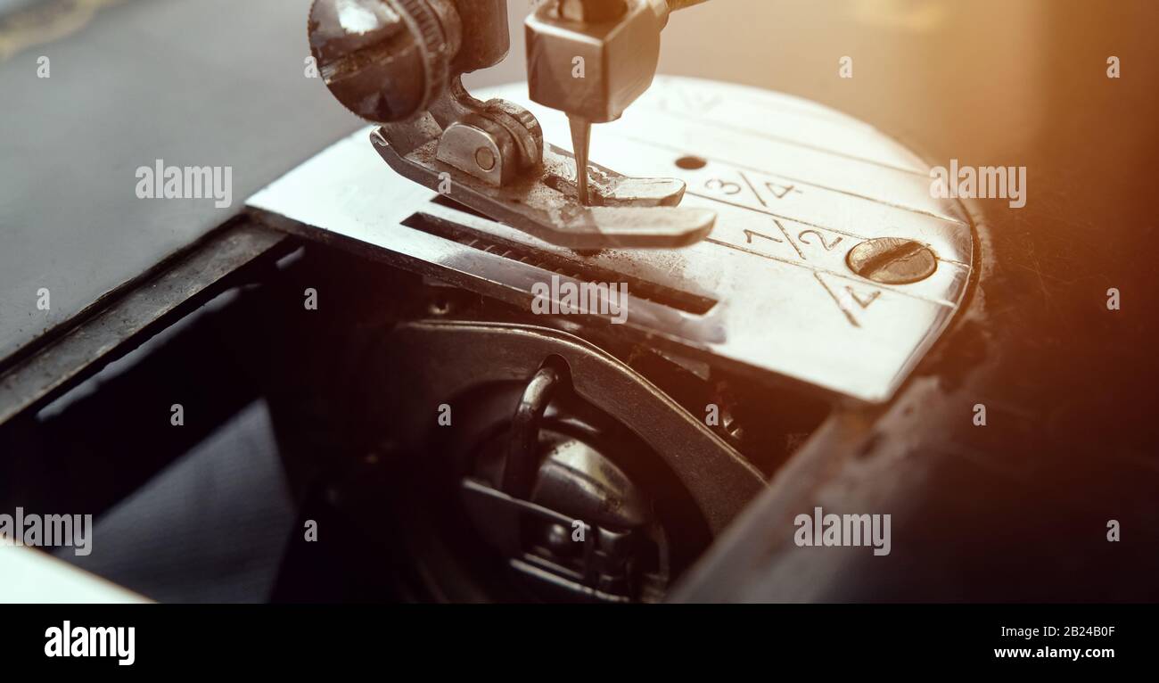 Old sewing machine feed dogs unit oil maintenance and thread spool