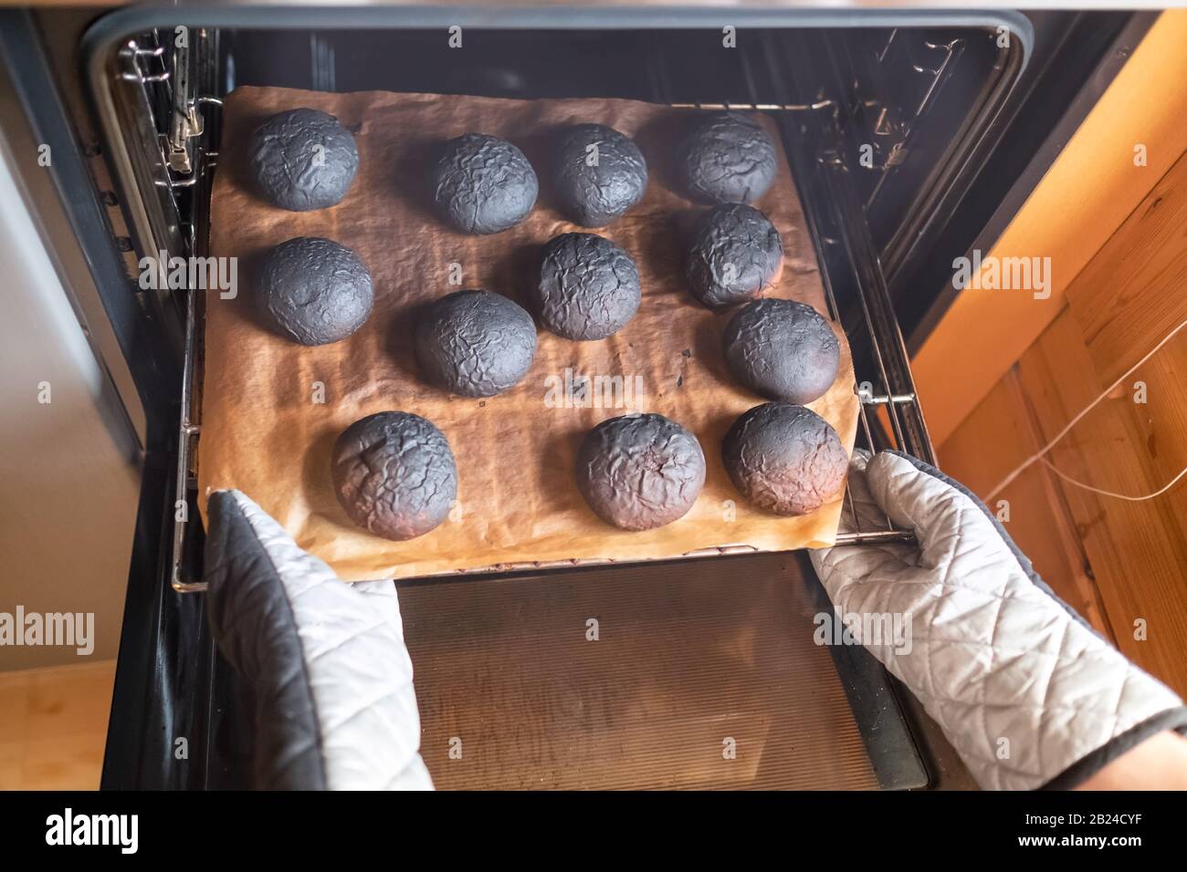 Woman has forogotten about preparing dinner. Burnt pancakes. Fried foods are unhealthy. Stock Photo