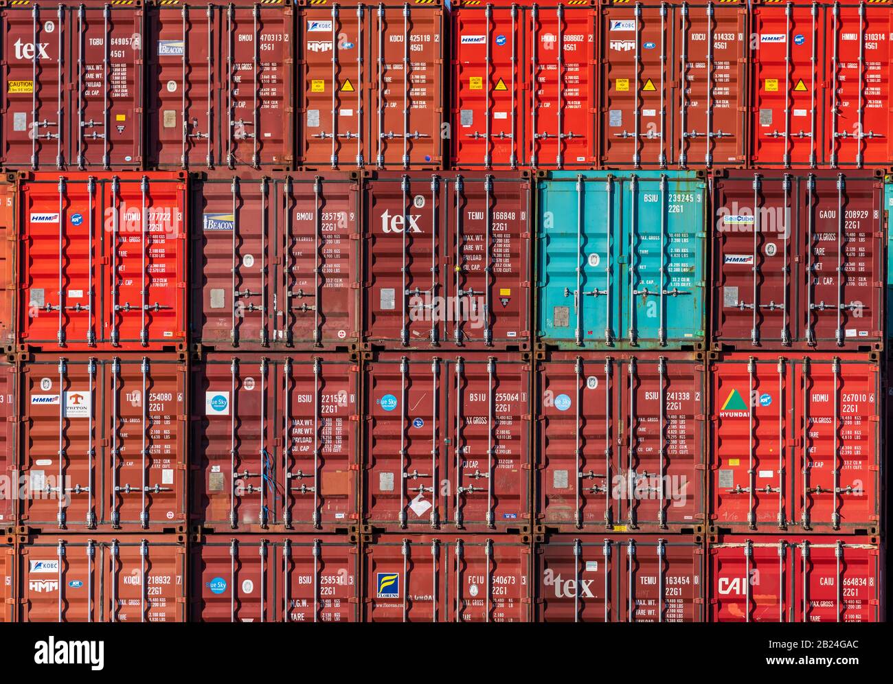 Shipping Containers - stacked shipping containers await loading onto ships at Felixstowe Port. Stock Photo
