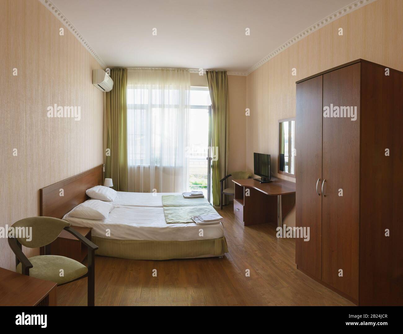 The bright hotel rooms of economy class with double bed Stock Photo - Alamy