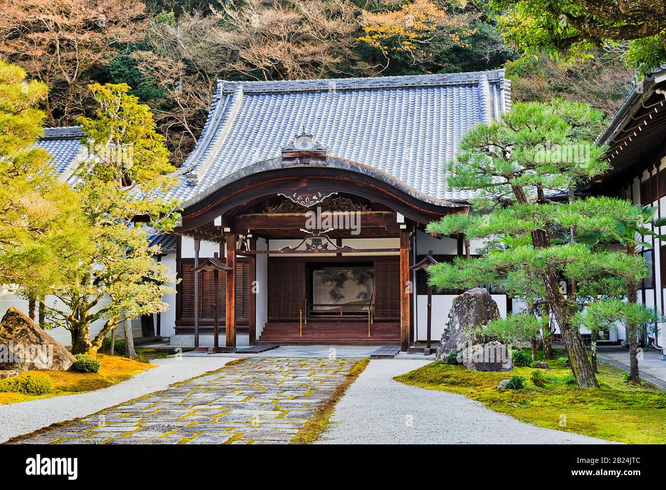 Small historic temple in Nanzen complex of Kyoto city surrounded by green park and traditional Japanese garden with pine trees. Stock Photo