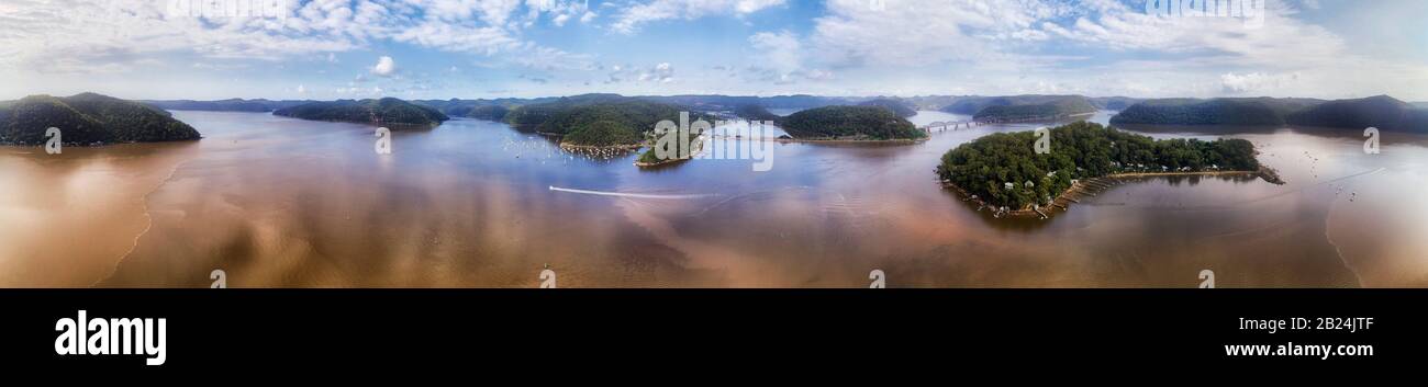 Wide aerial panorama of Hawkesbury river delta near entrance to Pacific ocean with river aquaculture and oysters farms between islands and coast. Stock Photo