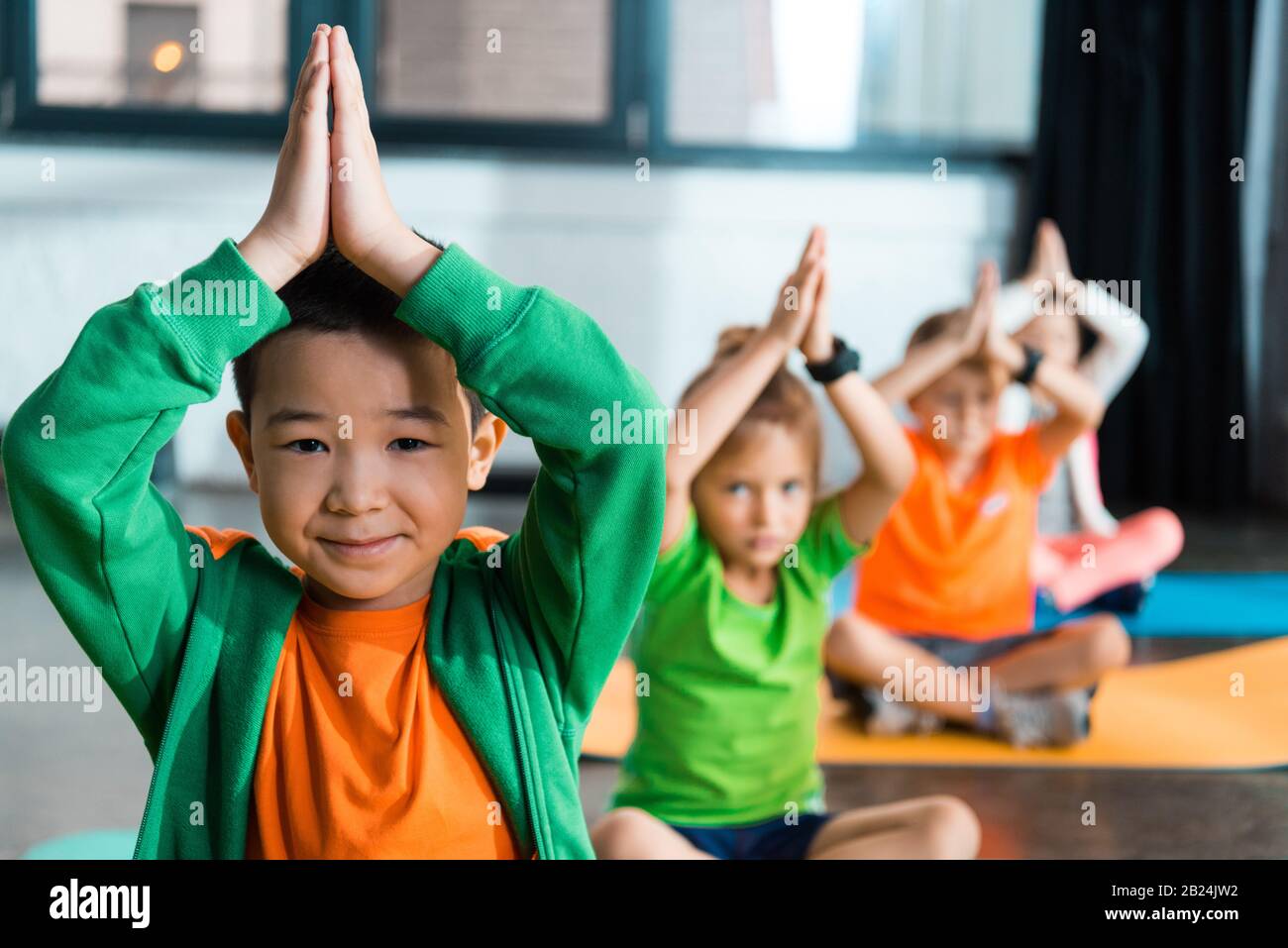 Selective focus of multicultural children with clenched hands ...
