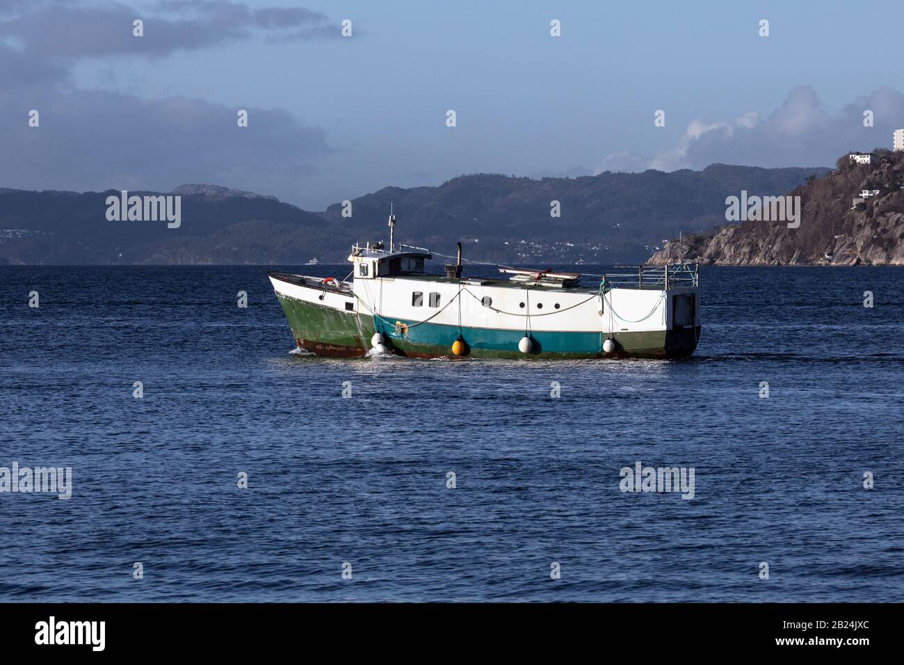 Originally a fishing vessel (built 1975), now a rebuilding project, the vessel Breiflu at Byfjorden, departing from the port of Bergen, Norway Stock Photo