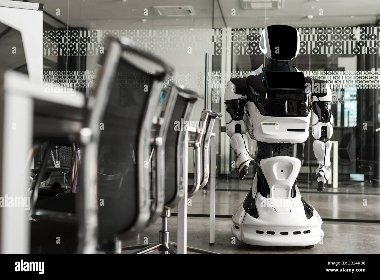 selective focus of humanoid robot standing in conference hall of modern ...