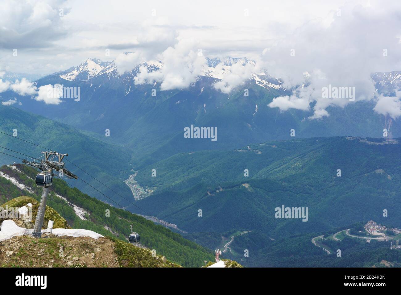 The cable car in ski resort, in summer a cloudy day. Mountain peaks hiding in the clouds Stock Photo