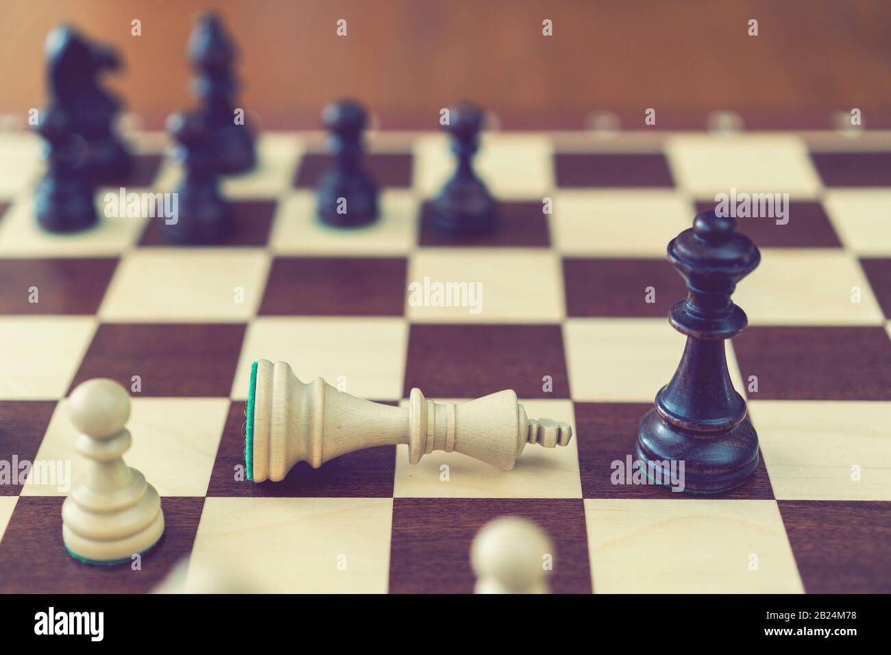 Concept of defeat, fallen king, camera focus on white king chess piece,  background blurred. chess board with chess wooden pieces. toned Stock Photo  - Alamy