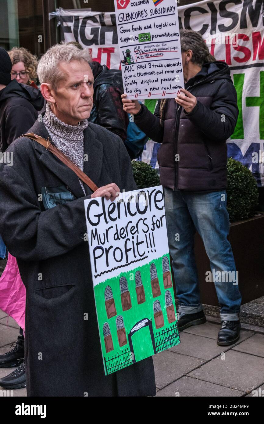 London, UK. 29th February 2020. 'Glencore Murderers for Profit!!!'. Earth Strike and other climate activists protest at the Mayfair offices of part British-owned multinational mining company Glencore.  One of the world's largest producers of coal, they profit from ecological destruction to extract minerals like cobalt, copper and lithium vital in smartphones, computers and electric cars. Congolese families are suing them over children killed or maimed in their mines, and protesters against their mining in several countries have been violently attacked by police or murdered. Peter Marshall/Alam Stock Photo